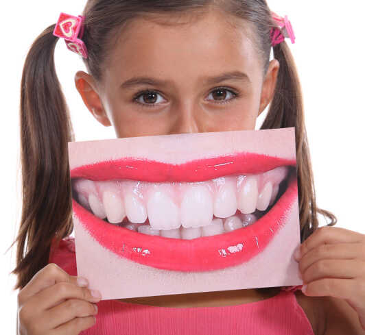 Kid holding photo of a white smile